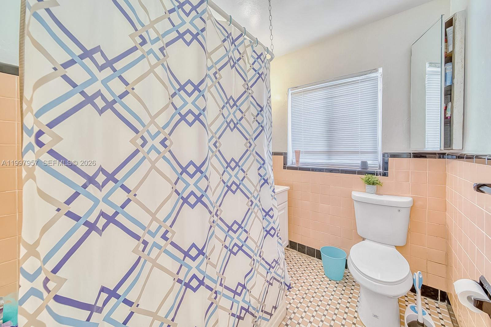 2171 Southwest 21st Street Miami, FL 33145 - Photo 11 of 31 a bathroom with a toilet and a shower curtain