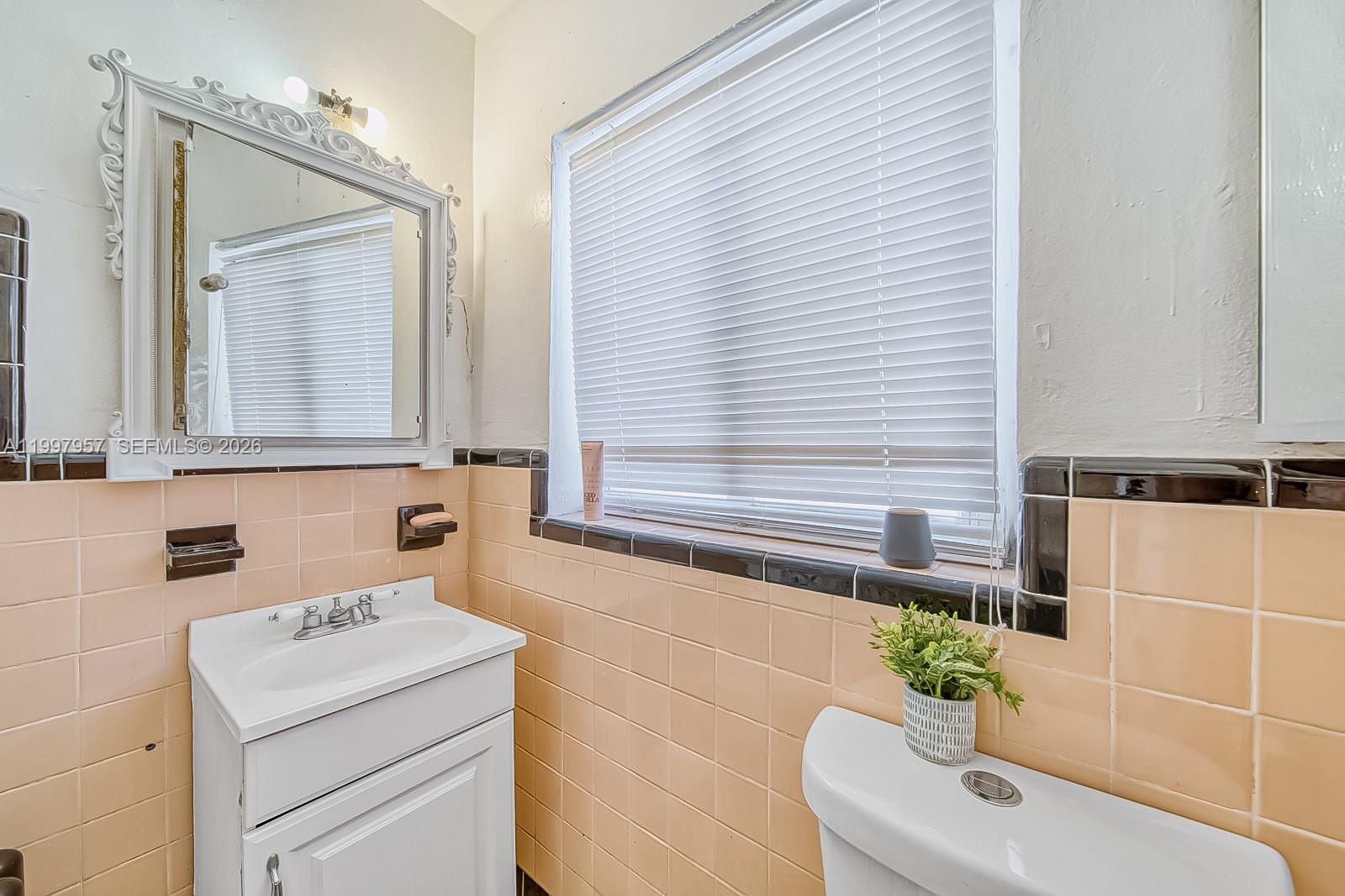 2171 Southwest 21st Street Miami, FL 33145 - Photo 26 of 31 a bathroom with a sink a toilet and mirror