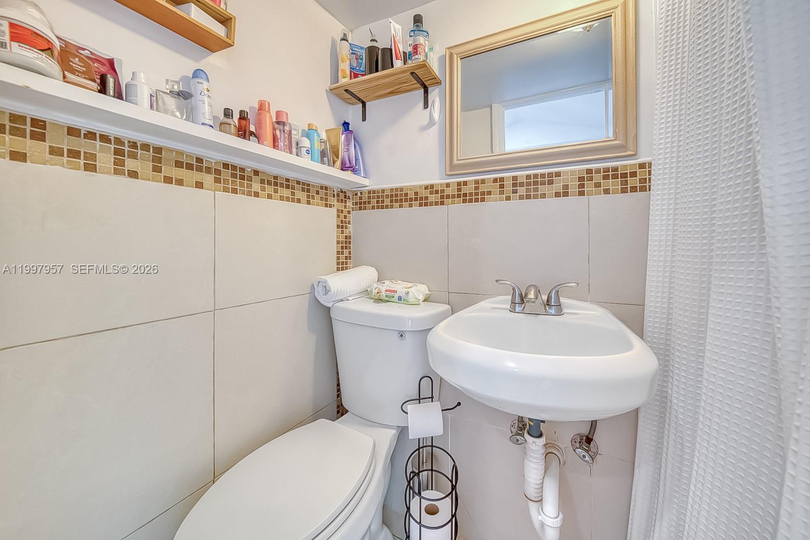2171 Southwest 21st Street Miami, FL 33145 - Photo 28 of 31 a bathroom with a sink a mirror and a toilet