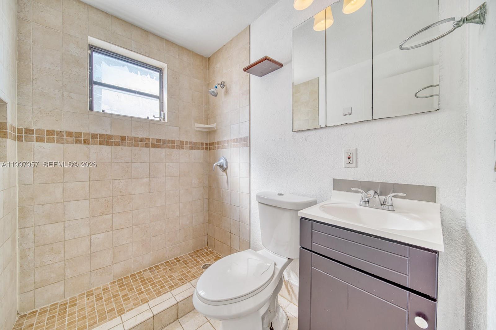 2171 Southwest 21st Street Miami, FL 33145 - Photo 6 of 31 a bathroom with a sink toilet and shower