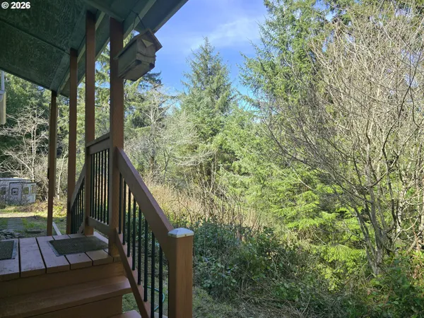 a view of balcony with wooden floor and fence