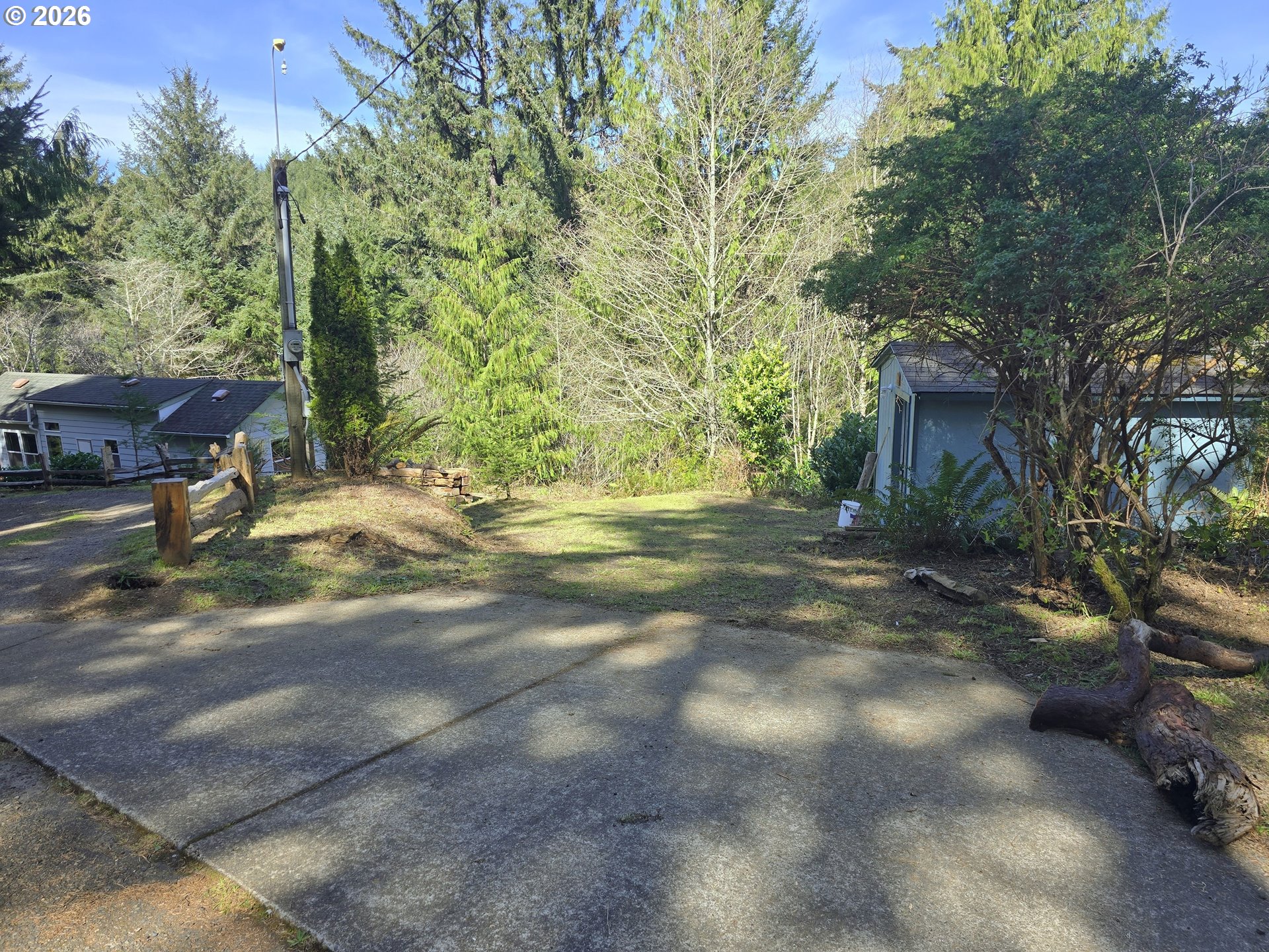 89491 Sutton Place Florence, OR 97439 - Photo 16 of 21 a view of a yard with plants and trees