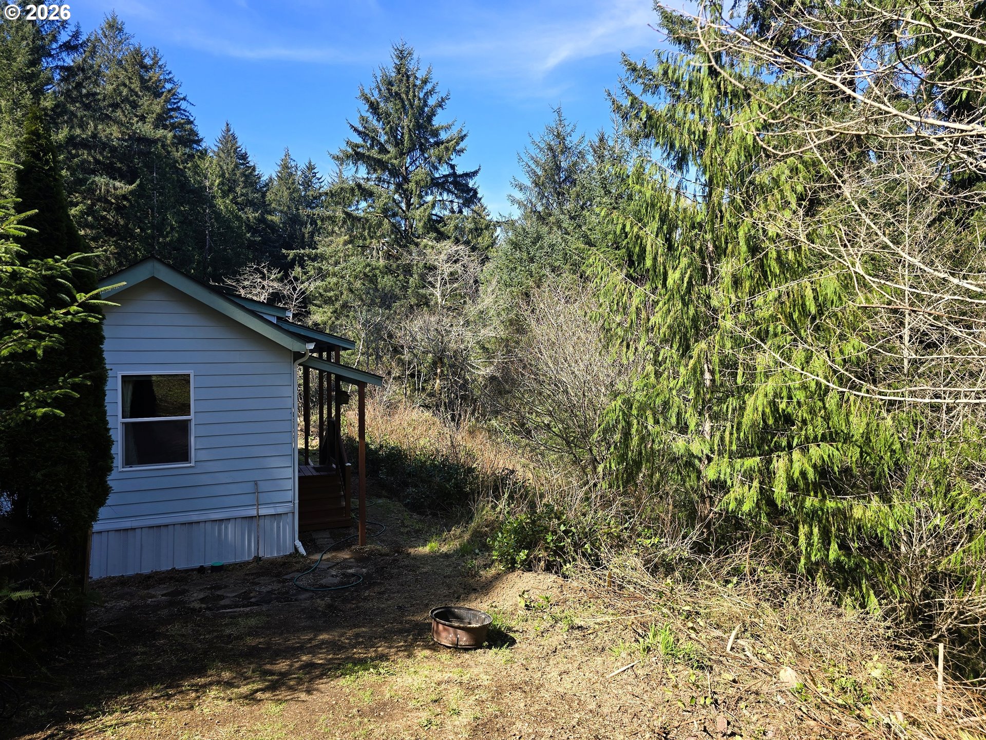 89491 Sutton Place Florence, OR 97439 - Photo 18 of 21 a backyard of a house with lots of green space
