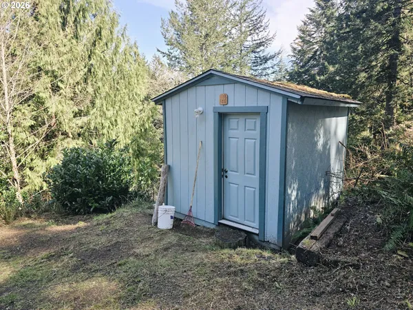 a view of a wooden house with a small yard