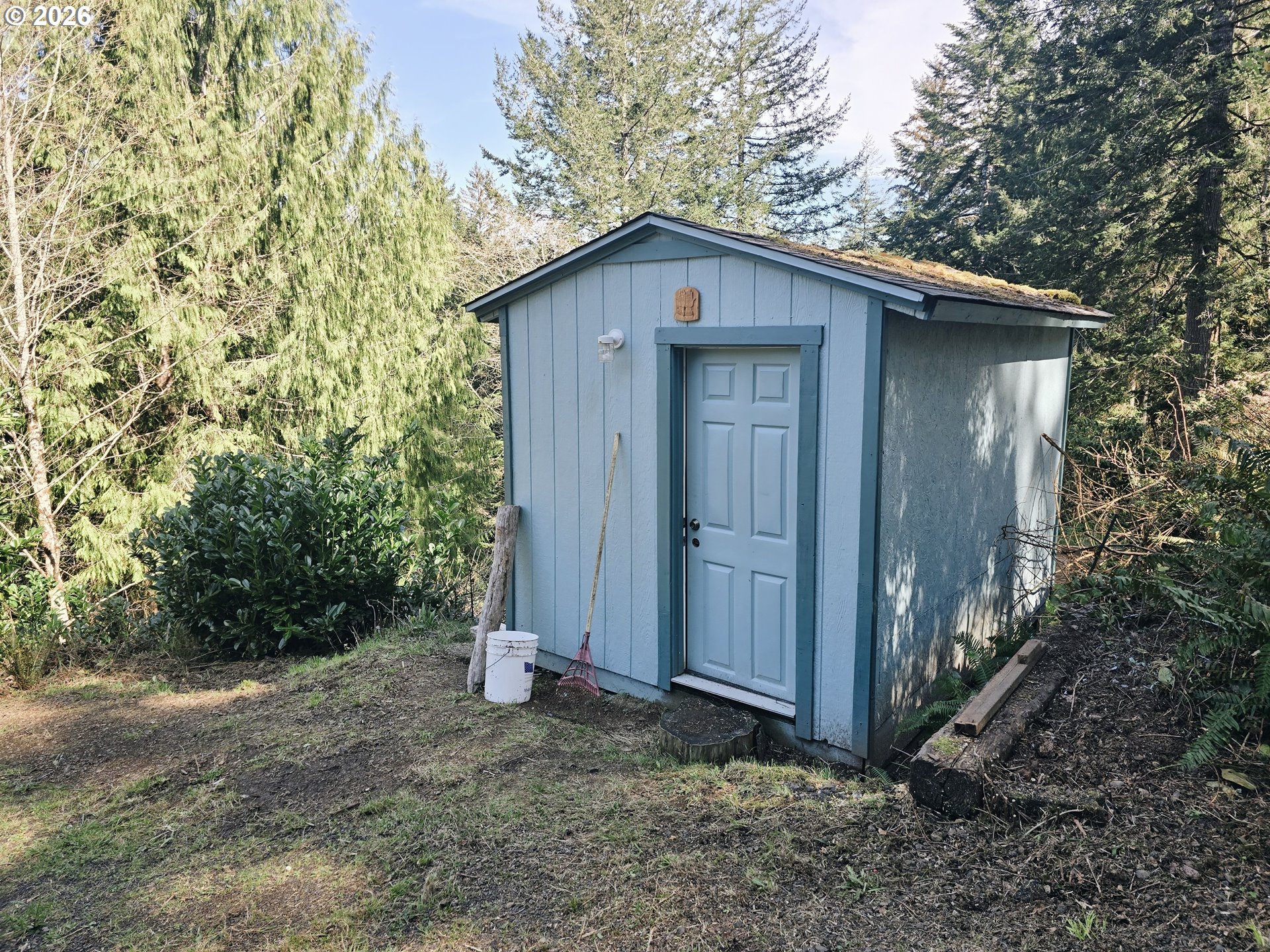 89491 Sutton Place Florence, OR 97439 - Photo 21 of 21 a view of a wooden house with a small yard