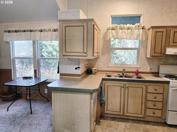 a kitchen with a sink cabinets and window