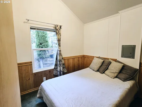 a bedroom with a bed and a window