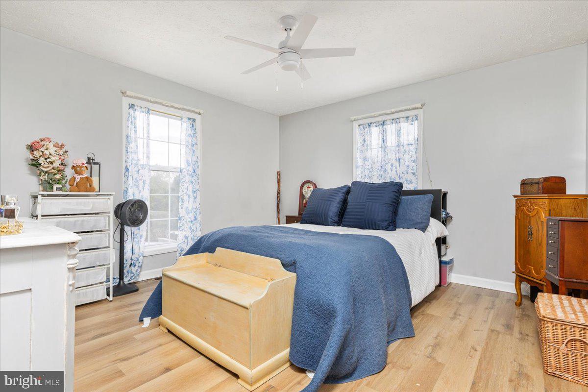 10346 Groves Farm Road Midland, VA 22728 - Photo 15 of 36 a bedroom with a bed and a chandelier