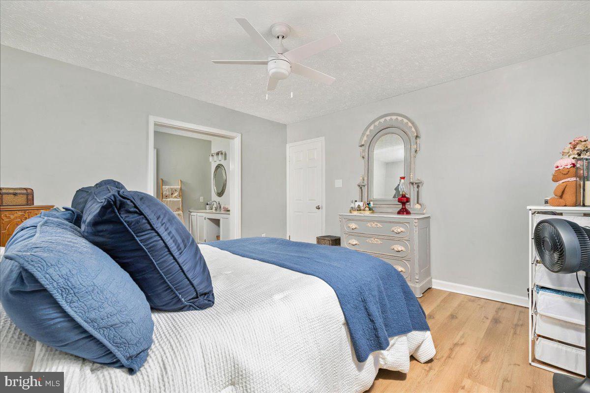 10346 Groves Farm Road Midland, VA 22728 - Photo 16 of 36 a bedroom with a bed and a chandelier