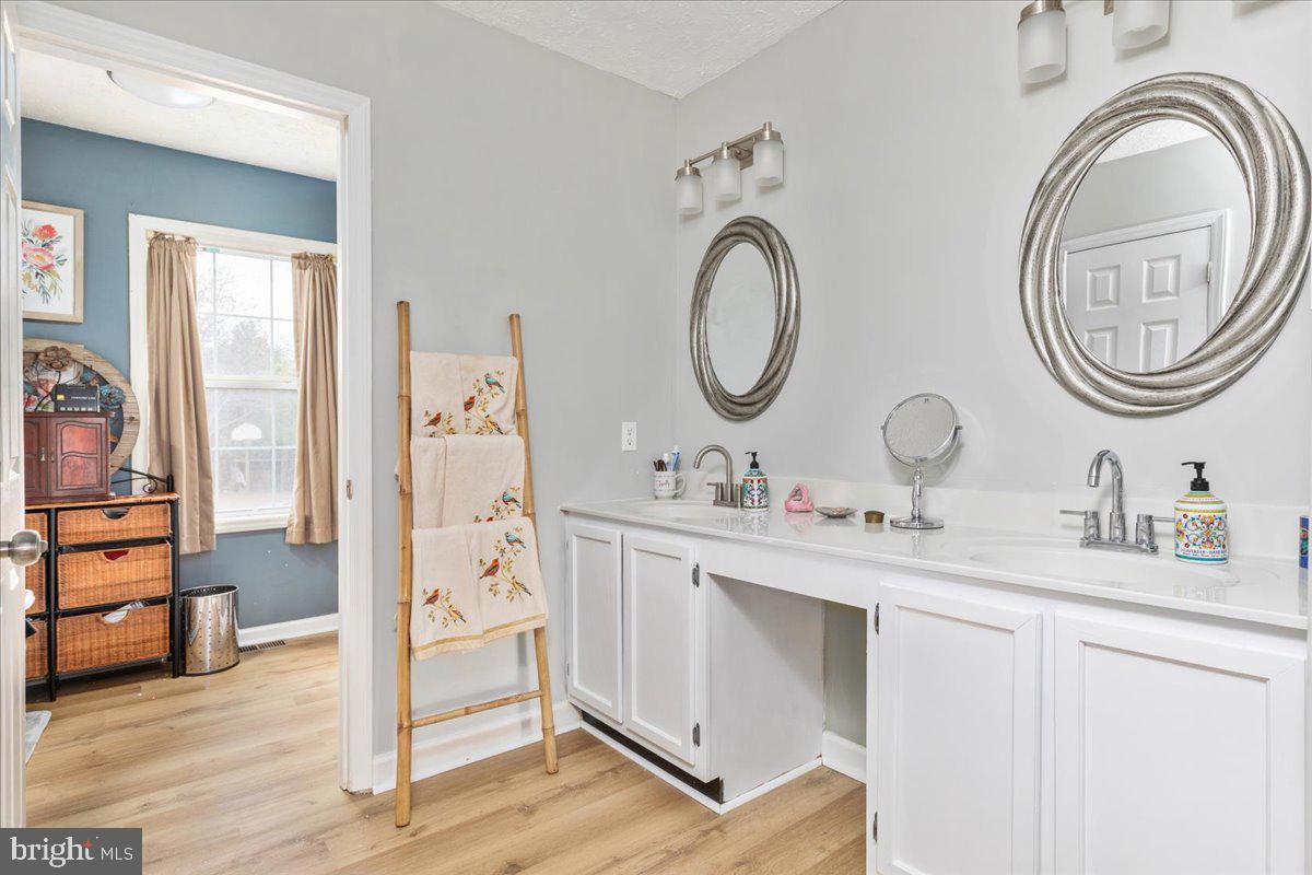 10346 Groves Farm Road Midland, VA 22728 - Photo 17 of 36 a spacious bathroom with a double vanity sink and a mirror