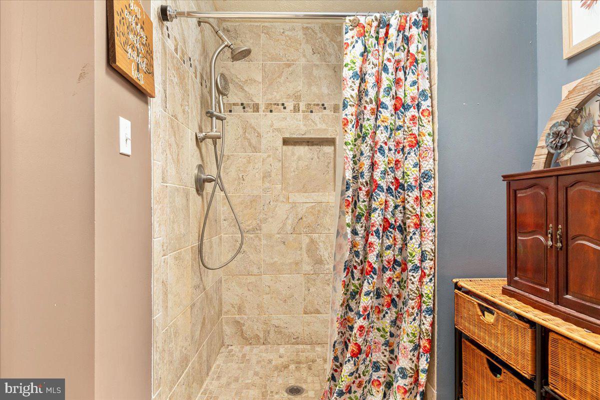 10346 Groves Farm Road Midland, VA 22728 - Photo 18 of 36 a bathroom with a shower curtain