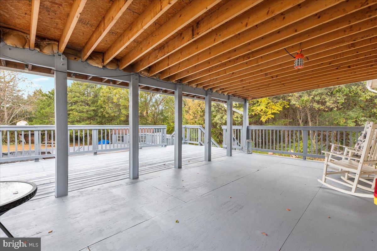 10346 Groves Farm Road Midland, VA 22728 - Photo 20 of 36 a view of a patio with table and chairs and wooden fence