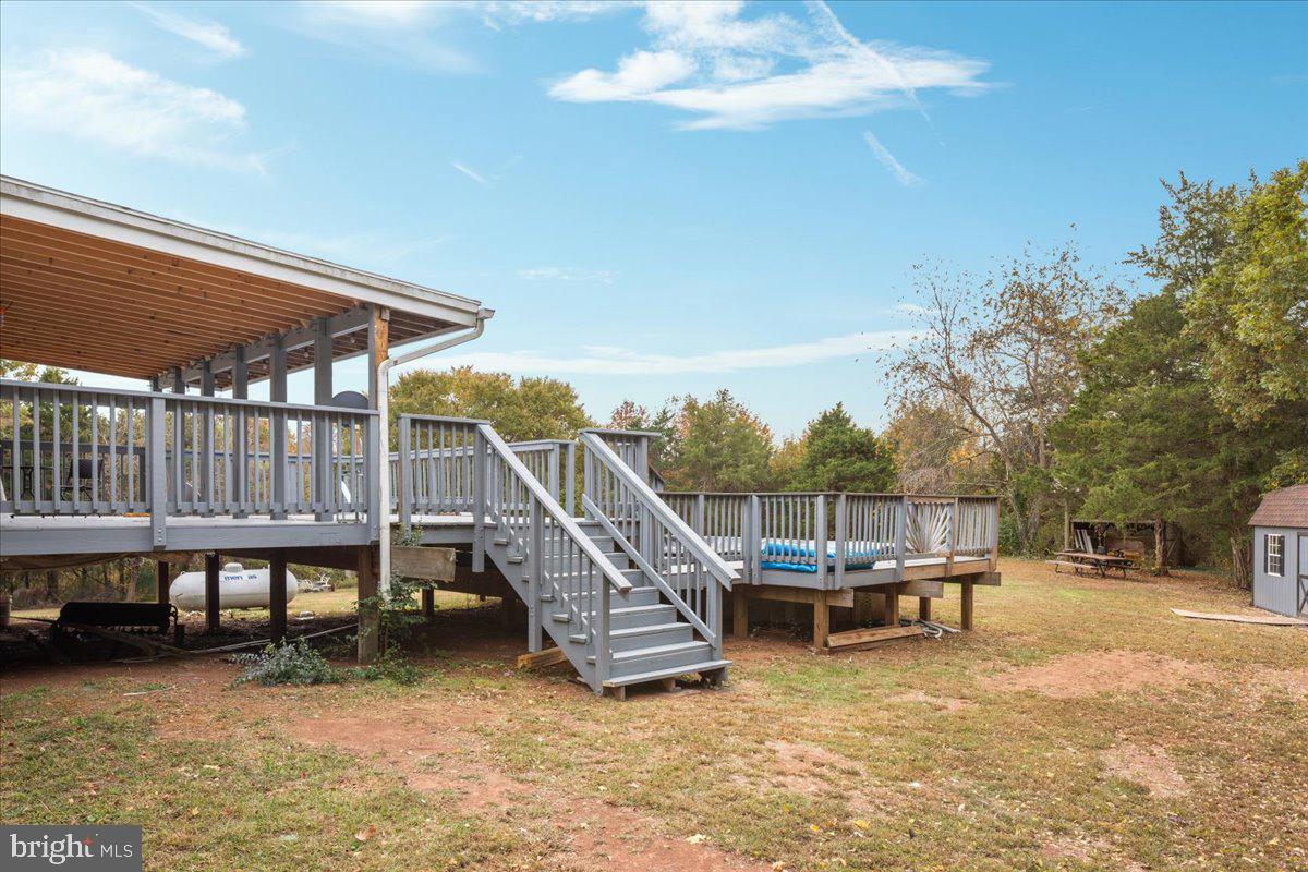10346 Groves Farm Road Midland, VA 22728 - Photo 23 of 36 a view of a roof deck with table and chairs