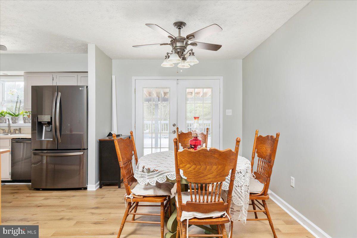 10346 Groves Farm Road Midland, VA 22728 - Photo 6 of 36 a dining room with furniture a chandelier and wooden floor