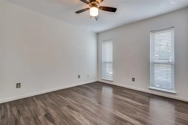 a bathroom with a granite countertop sink a toilet and a mirror