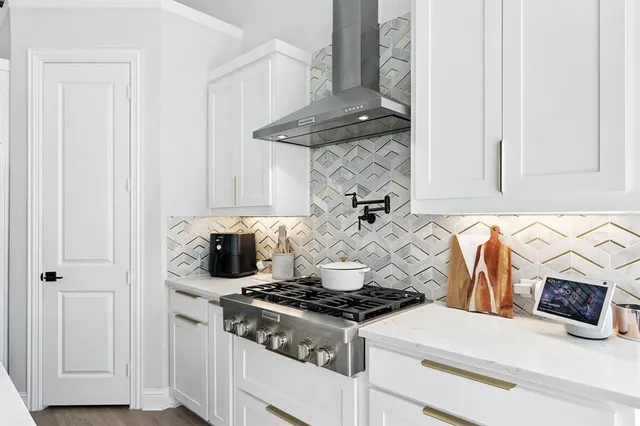 a white stove top oven sitting inside of a kitchen