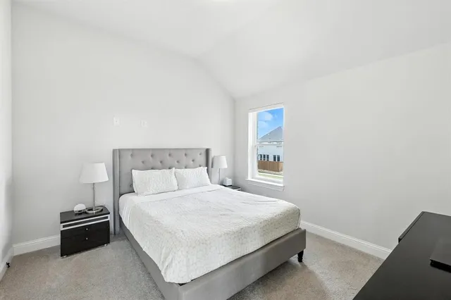 a bedroom with a bed and a night stand