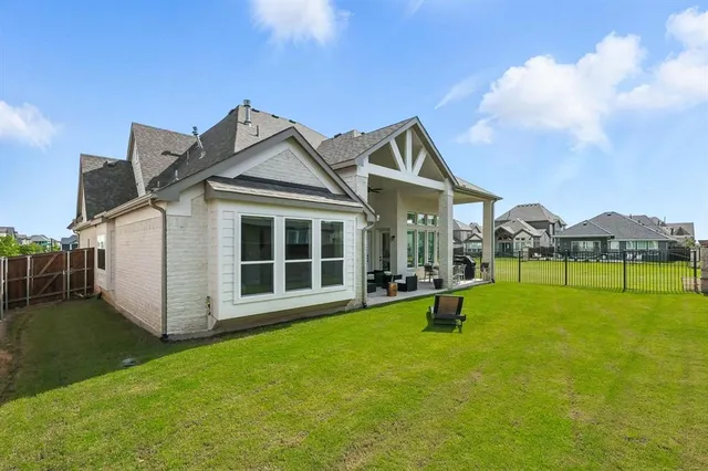 a view of a house with pool and a yard