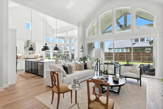 a living room with furniture fireplace and a large window