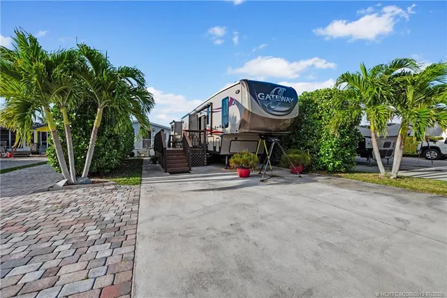 a view of a house with a swimming pool and a large tree