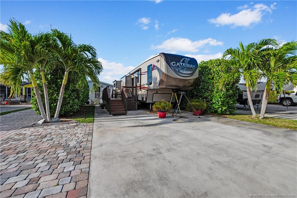 Undisclosed Address Jensen Beach, FL 34957 - Photo 14 of 47 a view of a house with a swimming pool and a large tree
