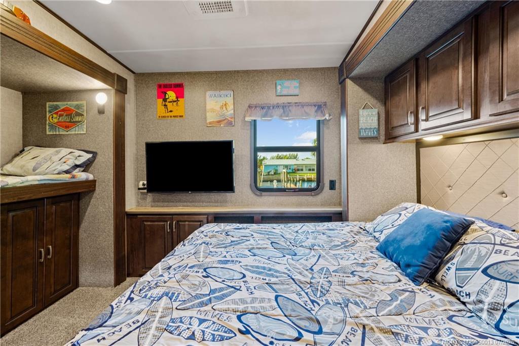 Undisclosed Address Jensen Beach, FL 34957 - Photo 19 of 47 a bedroom with a bed and a television