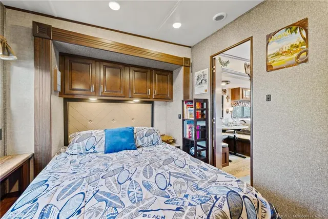 a bedroom with a bed and a refrigerator