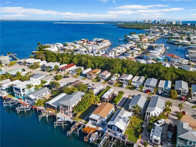 an aerial view of a houses with a lake view