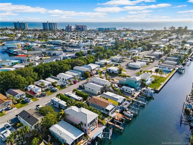 an aerial view of a house with a yard basket ball court and outdoor seating