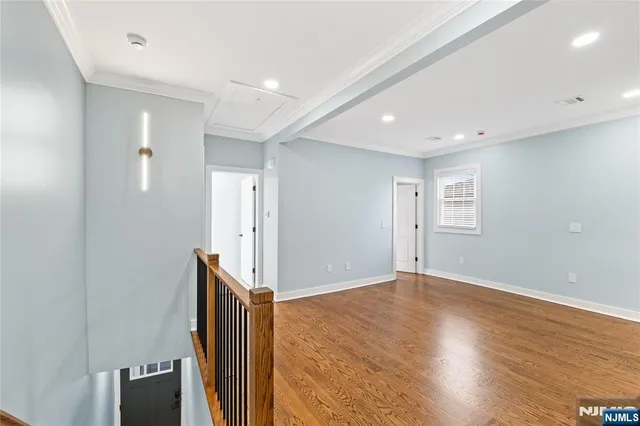 a kitchen with stainless steel appliances a refrigerator and wooden floor