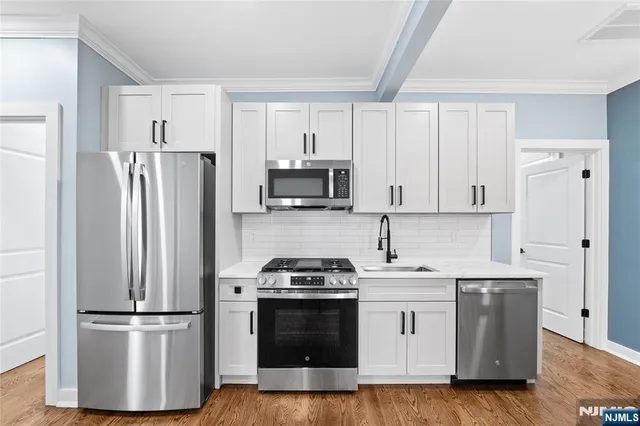 wooden floor in a room with a bathroom