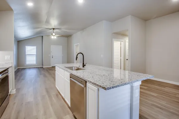 a kitchen with a sink and stove