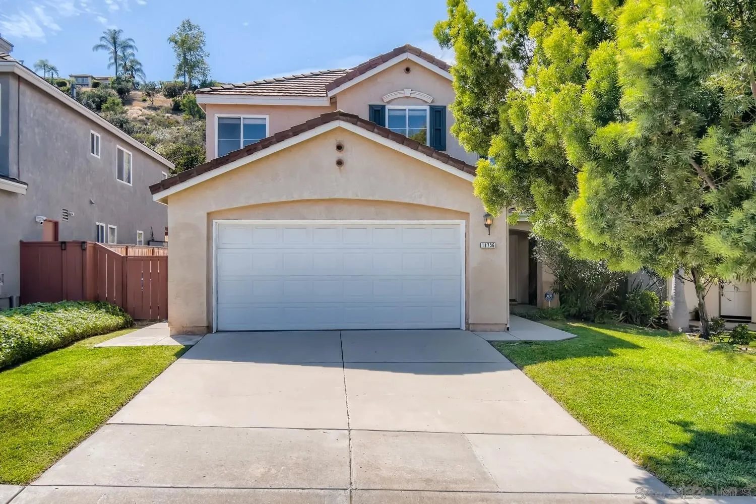 11756 Pickford Road San Diego, CA 92131 - Photo 1 of 26 a front view of a house with a yard and garage
