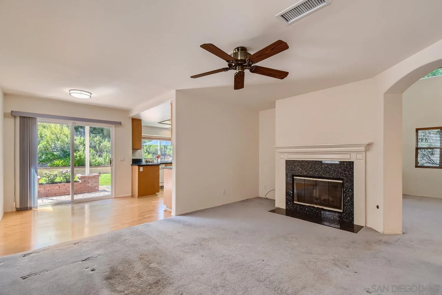 11756 Pickford Road San Diego, CA 92131 - Photo 11 of 26 a view of a livingroom with a fireplace and window