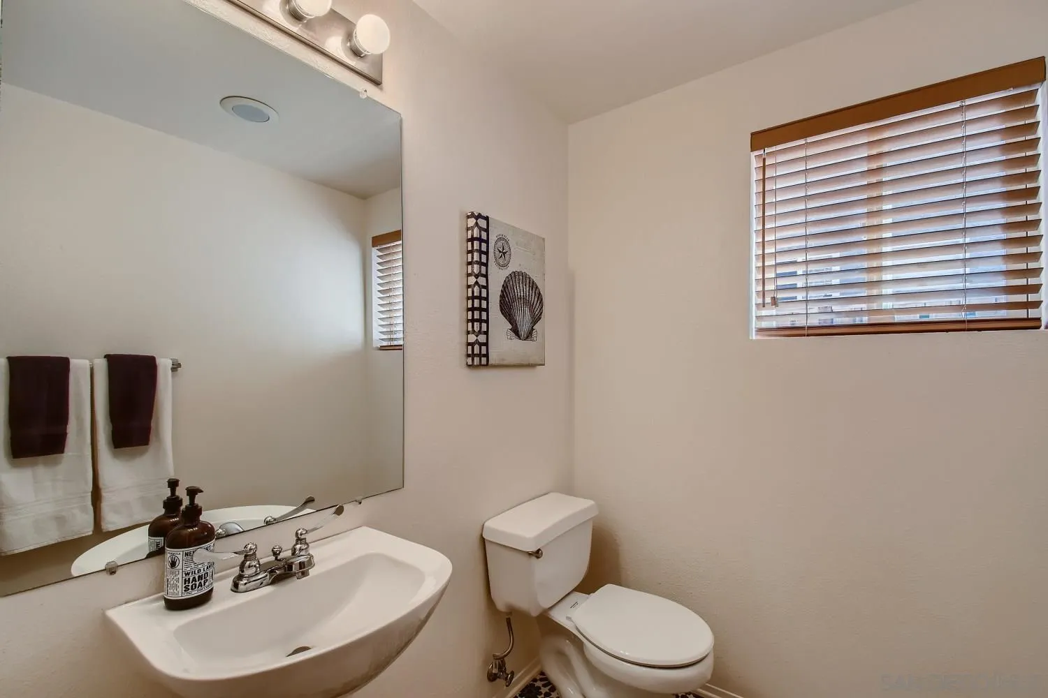 11756 Pickford Road San Diego, CA 92131 - Photo 13 of 26 a bathroom with a toilet sink and mirror