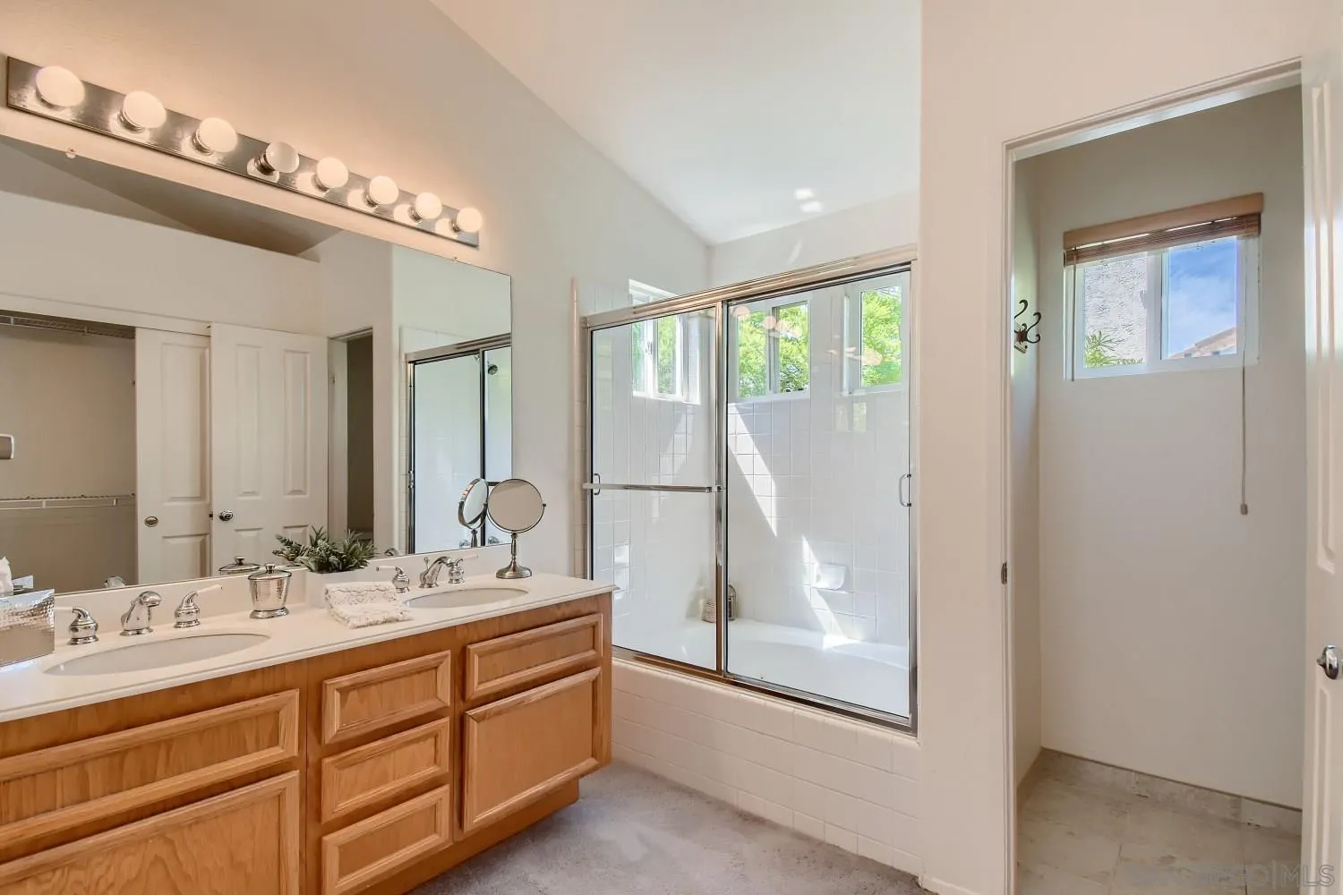 11756 Pickford Road San Diego, CA 92131 - Photo 17 of 26 a bathroom with a double vanity sink and a mirror