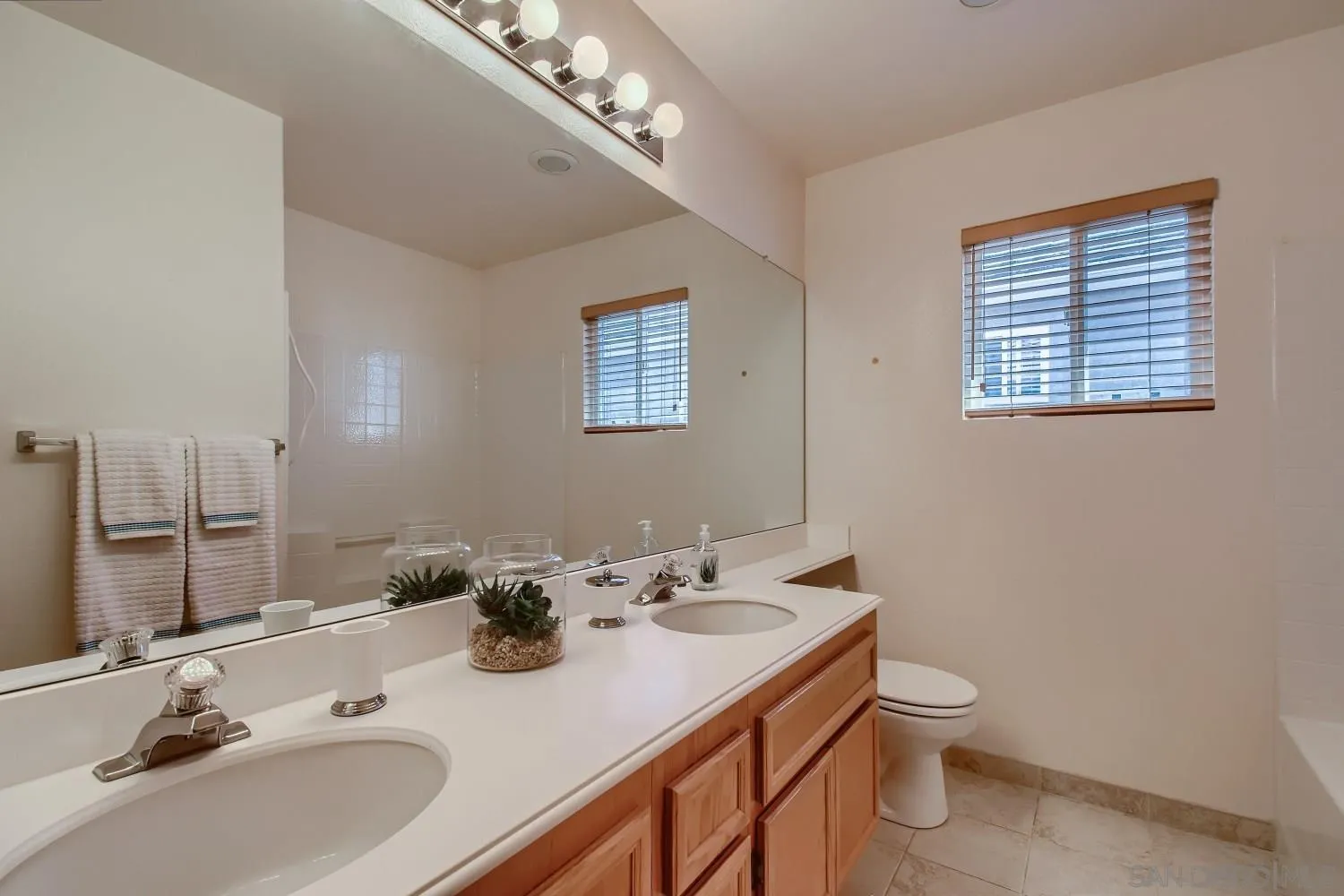 11756 Pickford Road San Diego, CA 92131 - Photo 21 of 26 a bathroom with a sink a toilet and a mirror