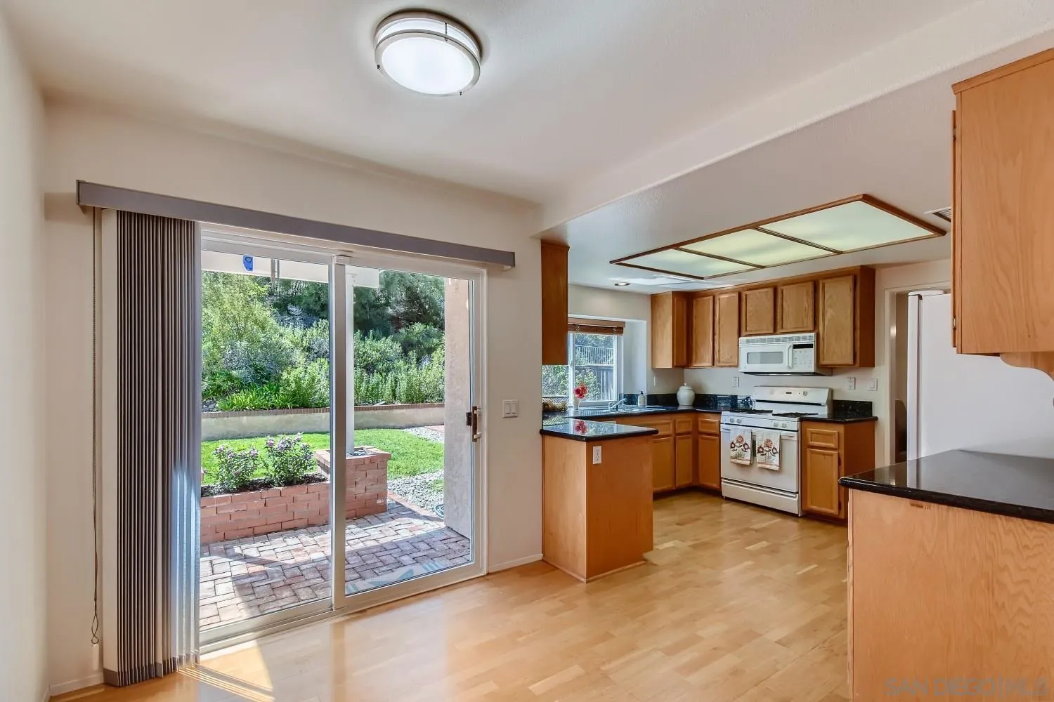 11756 Pickford Road San Diego, CA 92131 - Photo 8 of 26 a kitchen with a stove a sink and a refrigerator