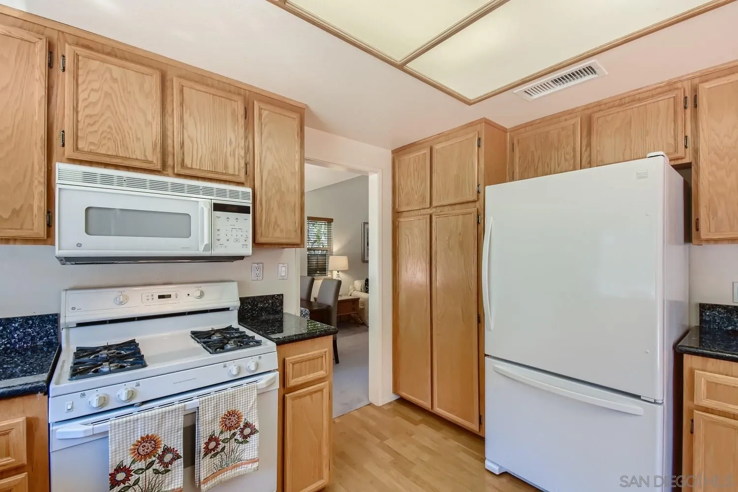 11756 Pickford Road San Diego, CA 92131 - Photo 9 of 26 a kitchen with a refrigerator stove and microwave