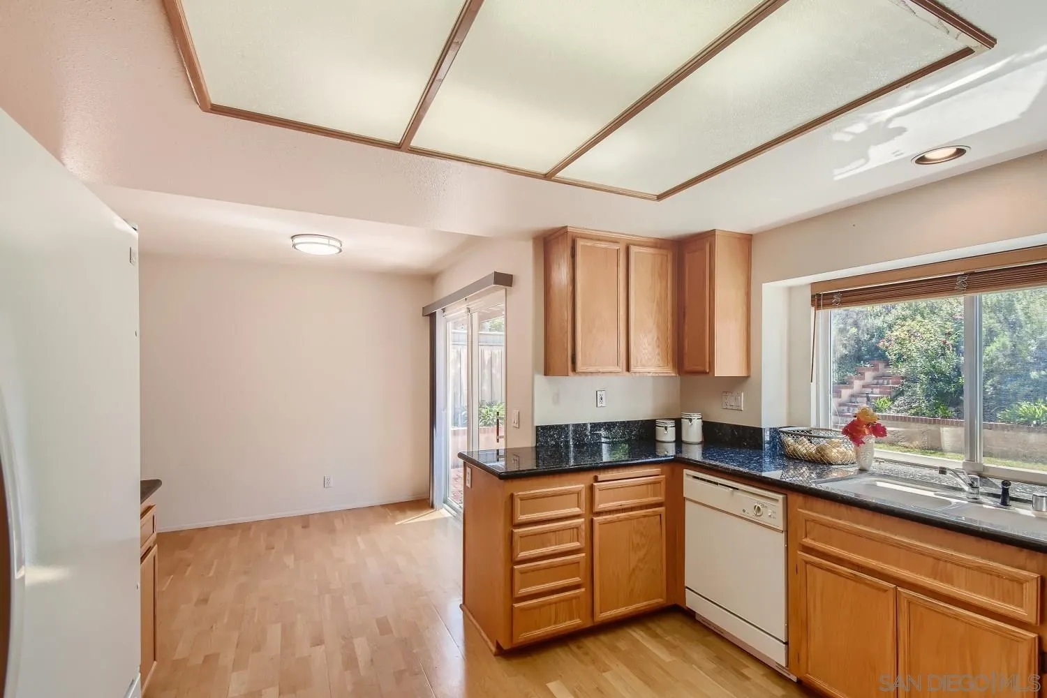 11756 Pickford Road San Diego, CA 92131 - Photo 10 of 26 a kitchen with granite countertop a sink window and cabinets