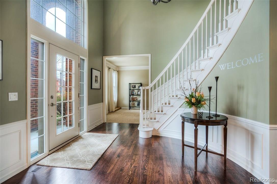 Greet your guests in the bright Foyer with hardwood floors and grand sweeping staircase.