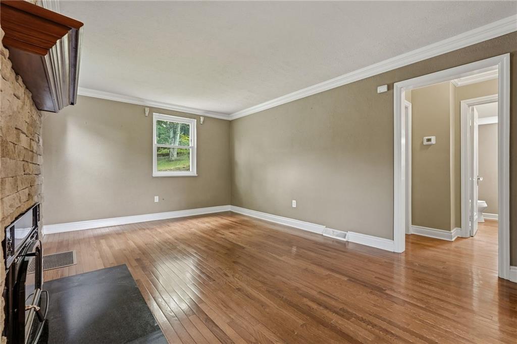 809 Franklin Road Mars, PA 16046 - Photo 7 of 44 Family room with hardwood floors, crown molding, and fireplace