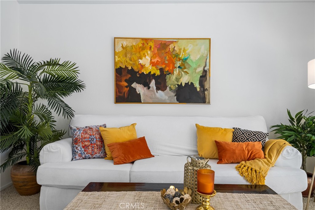 10 Brookstone Avenue Irvine, CA 92604 - Photo 13 of 67 a blue couch sitting in a living room with a rug