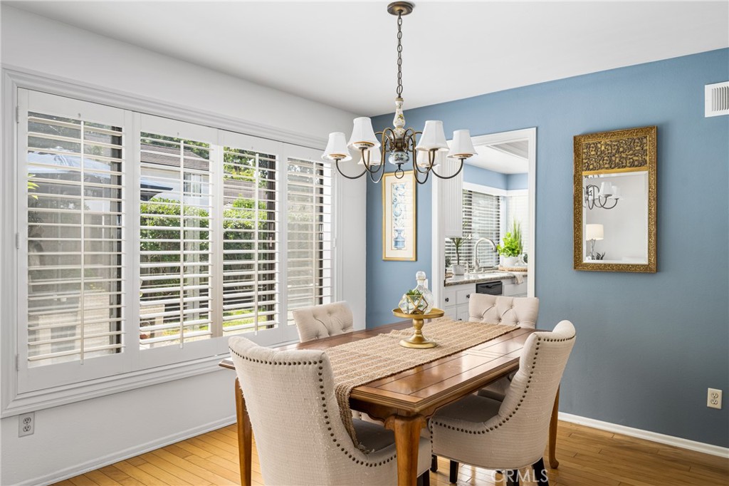 10 Brookstone Avenue Irvine, CA 92604 - Photo 18 of 67 a dining room with wooden floor a chandelier a wooden table and chairs