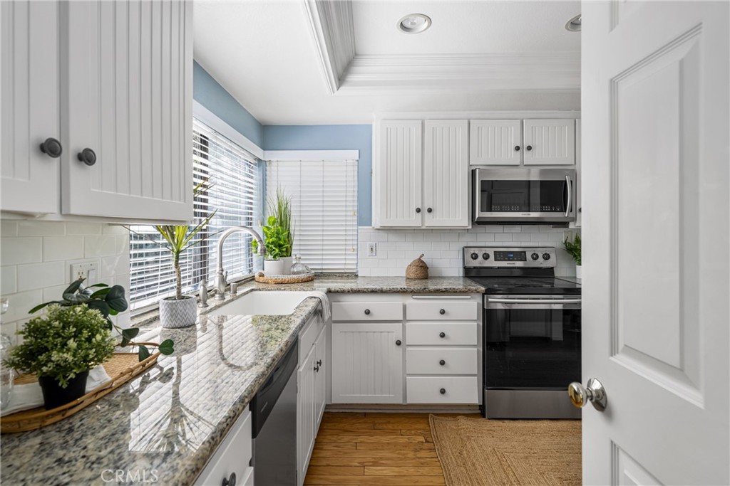 10 Brookstone Avenue Irvine, CA 92604 - Photo 20 of 67 a kitchen with a sink stove and microwave
