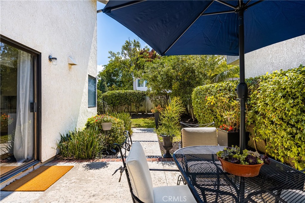 10 Brookstone Avenue Irvine, CA 92604 - Photo 44 of 67 a view of a patio with table and chairs potted plants and floor to ceiling window