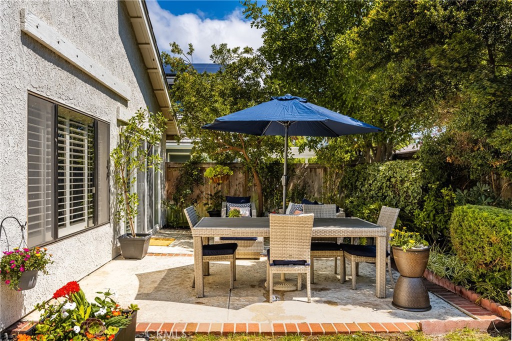 10 Brookstone Avenue Irvine, CA 92604 - Photo 52 of 67 a view of a patio with a table and chairs under an umbrella