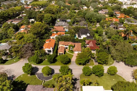 an aerial view of a house with a yard