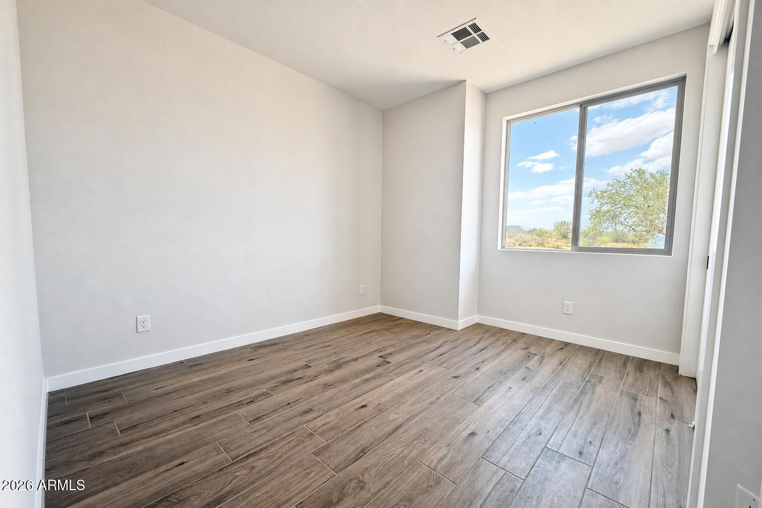 16957 East Bobwhite Way Rio Verde, AZ 85263 - Photo 14 of 25 an empty room with wooden floor and windows