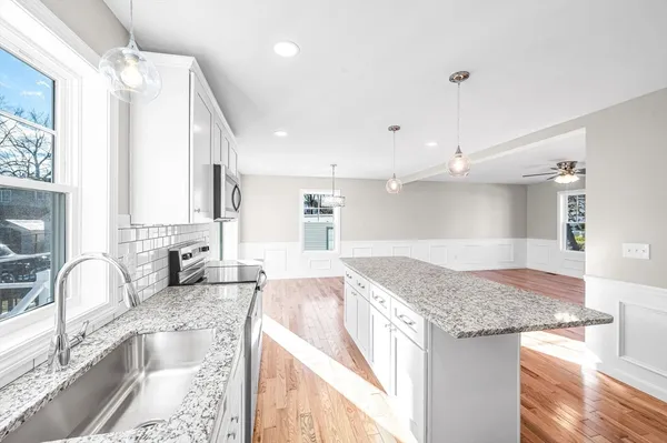 a kitchen with granite countertop a sink and a stove
